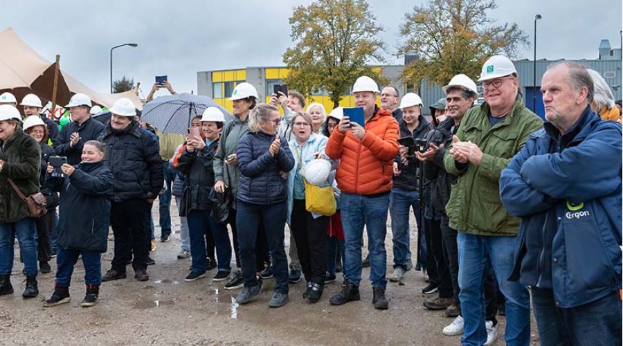 Medewerkers van Ergon kijken naar de start bouw van de wasserij.